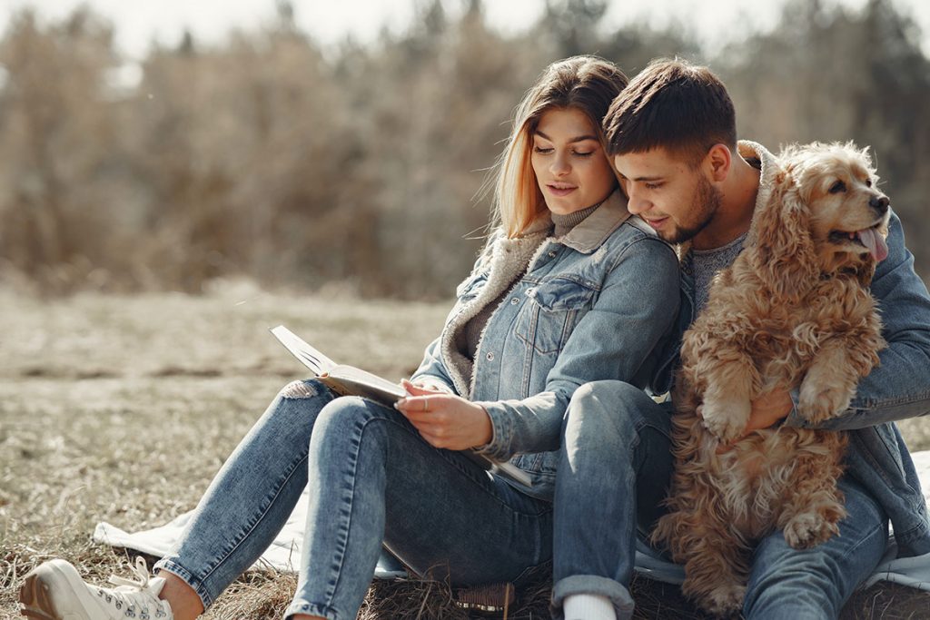 couple reading with dog